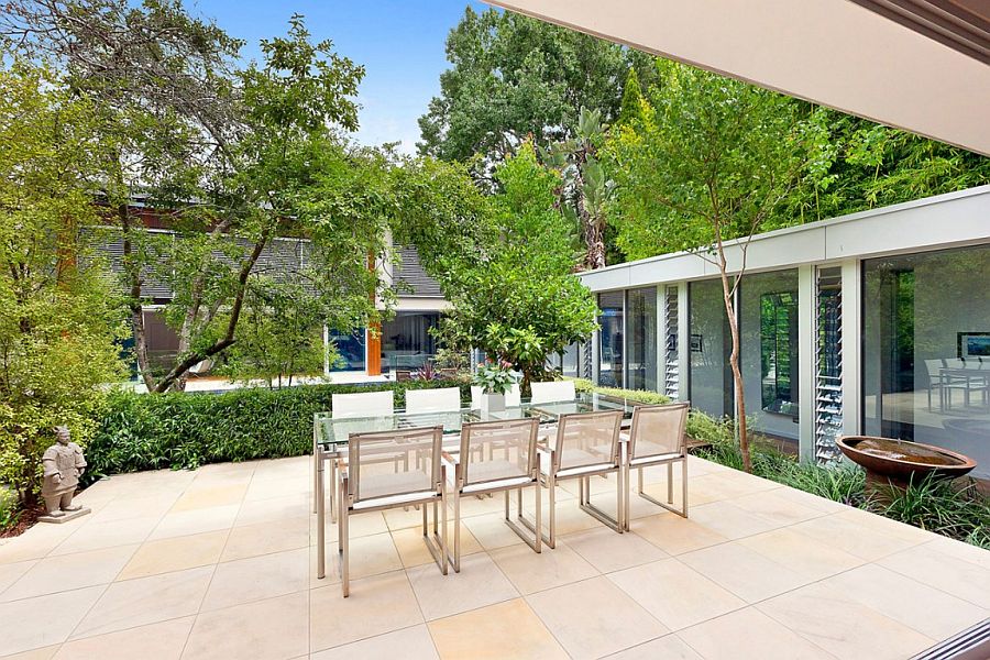 Outdoor dining space on an elevated platform with greenery all around