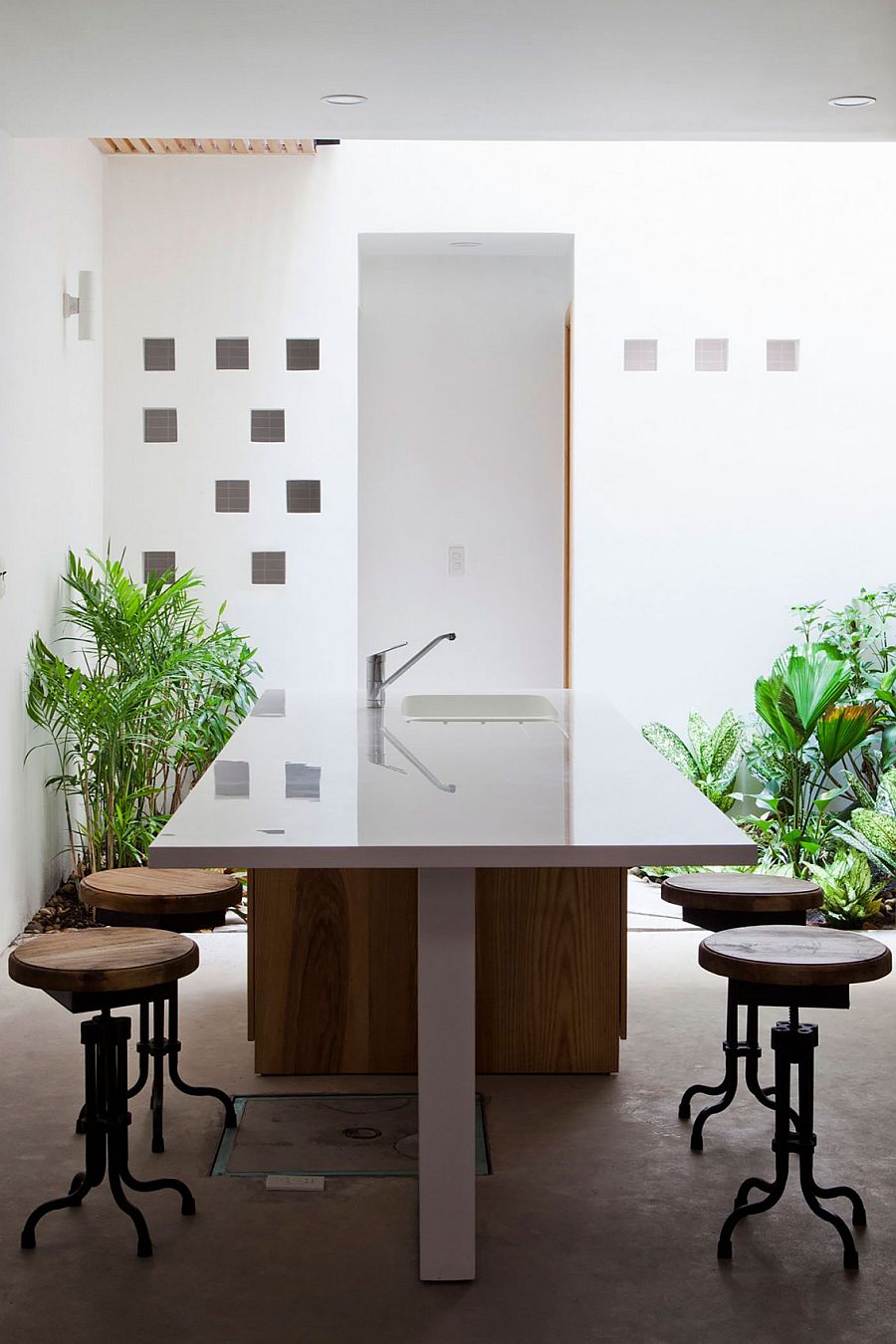 Polished kitchen workspace and dining zone with an access to the zone illuminated by skylight