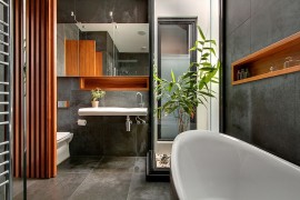 Restrained use of wooden elements bring cozy elegance to the concrete bathroom
