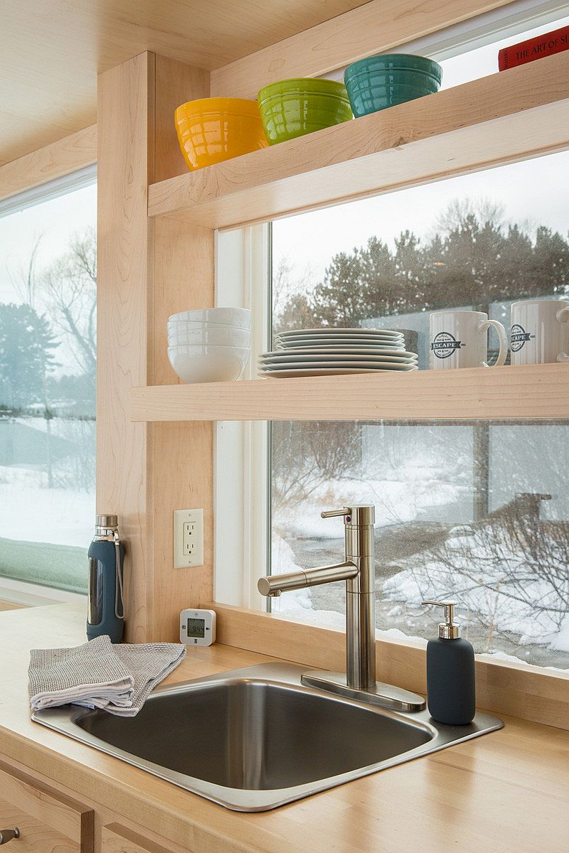 Shelves in the kitchen utilize vertical space without blocking the view