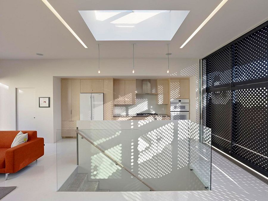 Skylight above the staircase brings natural light to even the lower levels of the house