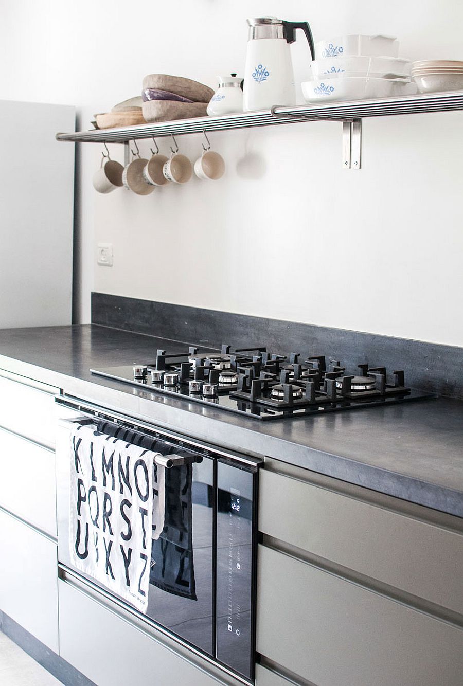 Sleek metallic floating shelf in the kitchen above the counter