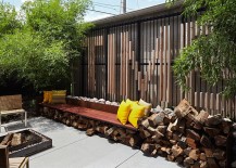 Small-backyard-with-concrete-deck-and-stacked-firewood-217x155