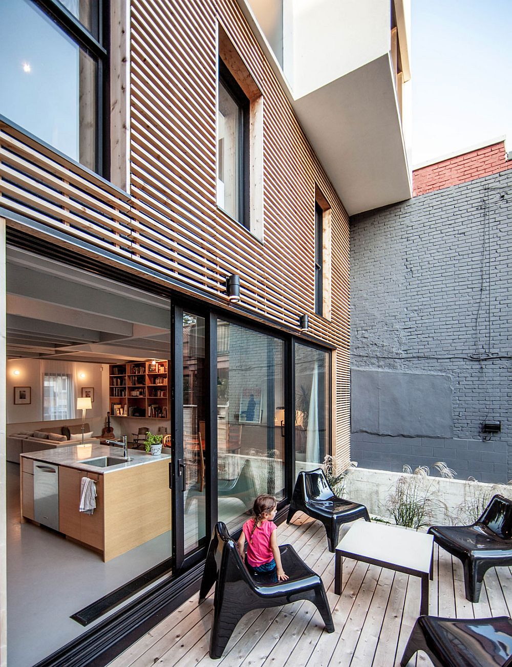 Small rear deck connected with the modern kitchen and living area of the Montreal home