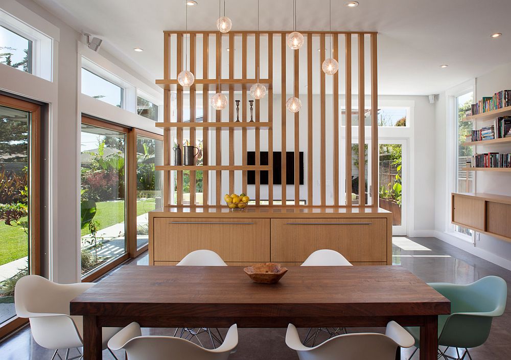 Smart cabinet design delineates the dining space from the living area