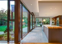 Spacious-kitchen-of-the-Seattle-home-connected-with-the-lush-green-landscape-outside-217x155
