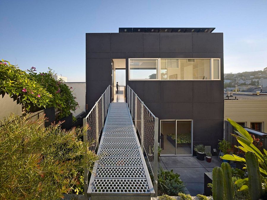 Steel walkway connects the penthouse level with the steep and hilly rear yard