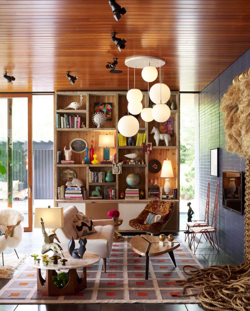 Styled bookshelf featuring treasures by Jonathan Adler