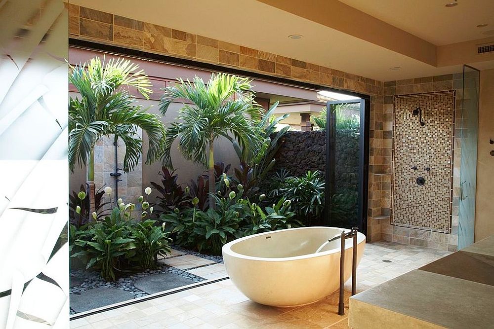 Tropical bathroom brings the outdoor garden inside with folding glass doors [Design: Knudson Interiors]