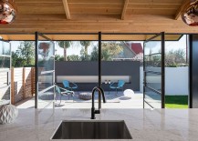 View-of-the-revamped-backyard-and-deck-from-the-spacious-glass-and-metal-extension-217x155