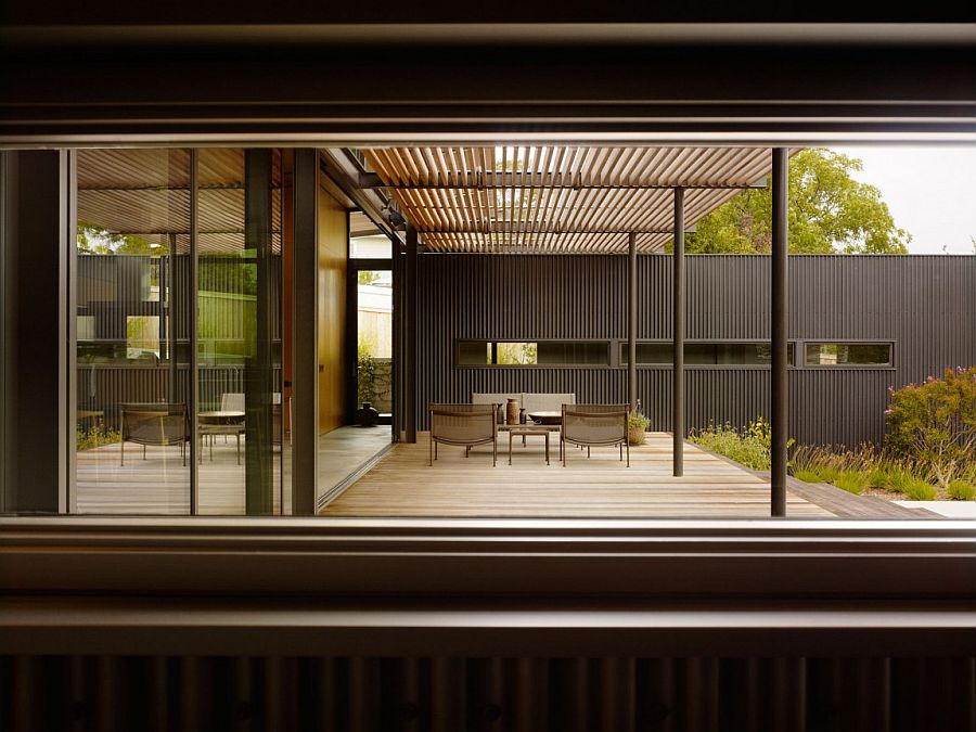 View of the shaded wooden deck of the stylish Californian home from within