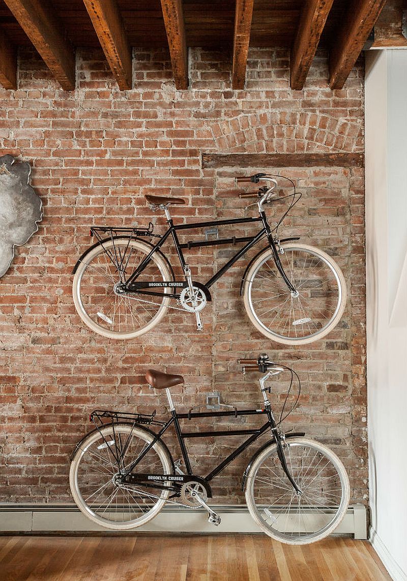 Wall-mounted bicycles alse serve as dramatic decorative pieces when set against a brick wall in the living room