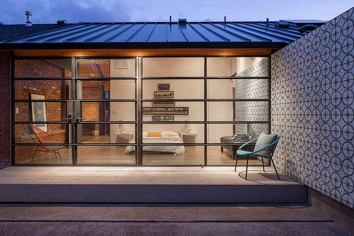 Wall of glass connects the bedroom with backyard