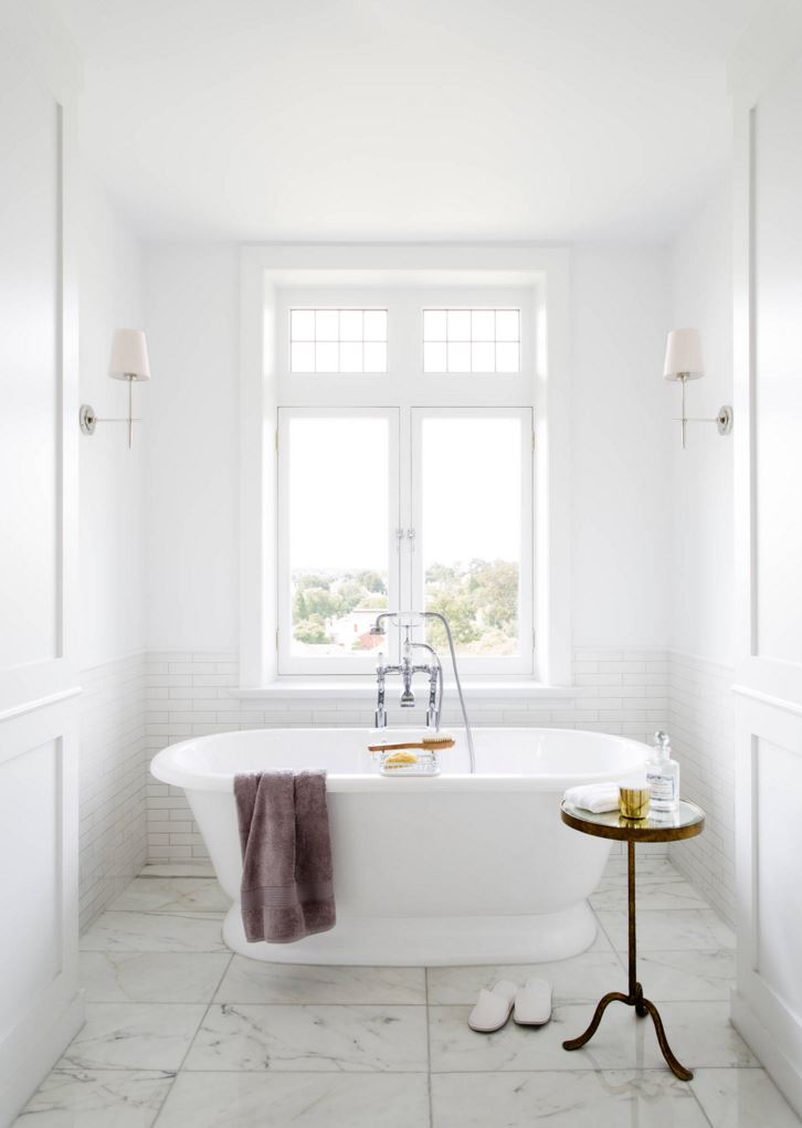 White bathroom with subway tile and marble tile