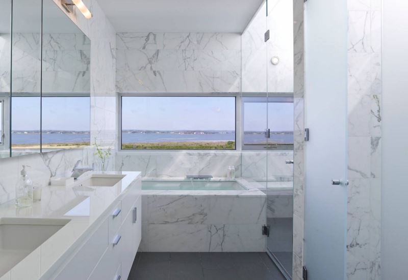 White marble bathroom with a view