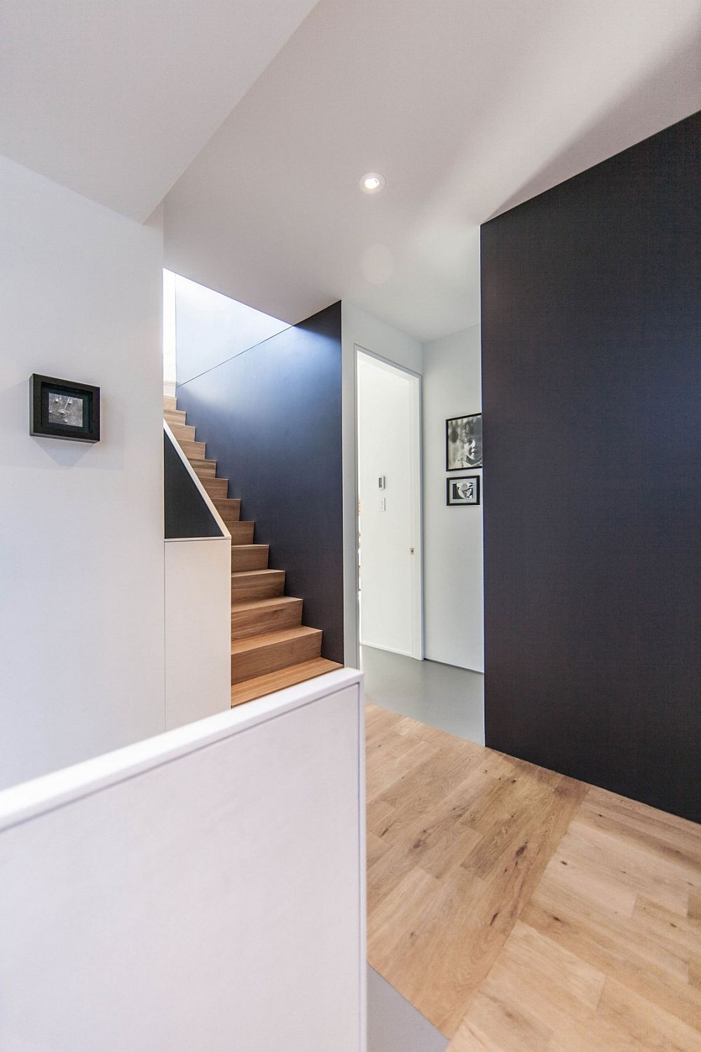 Wooden staircase and flooring bring a warmer texture to the interior