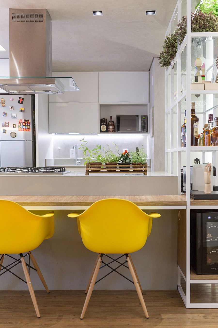 Yellow accents add brightness to the stylish and innovative kitchen