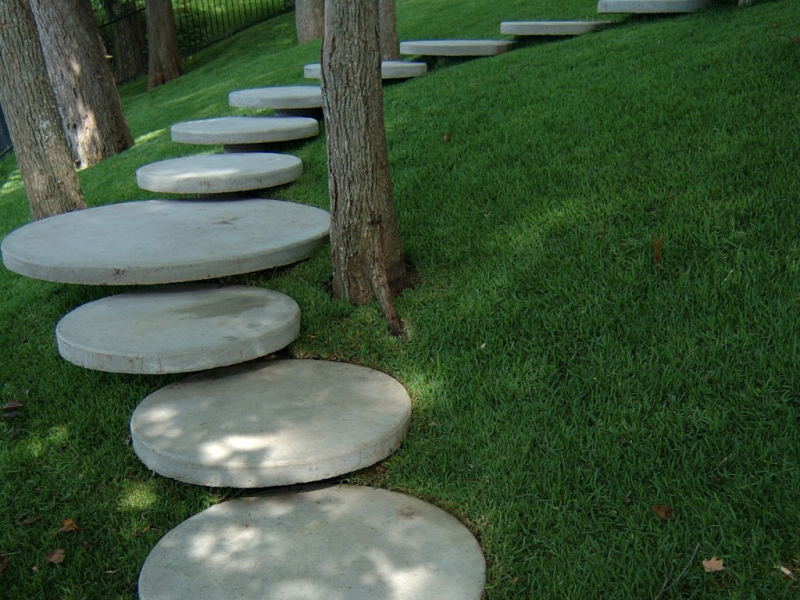 A sculptural staircase adds interest against a manicured lawn