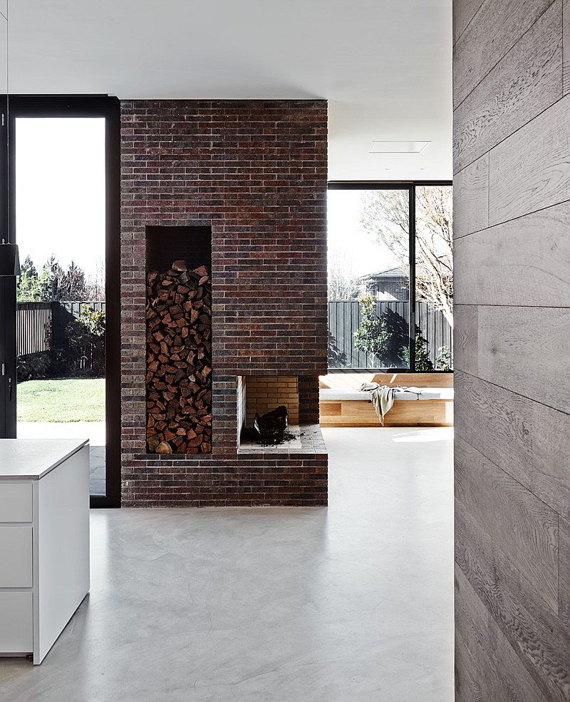 Brick fireplace in the new living space pays tribute to the original Victorian home
