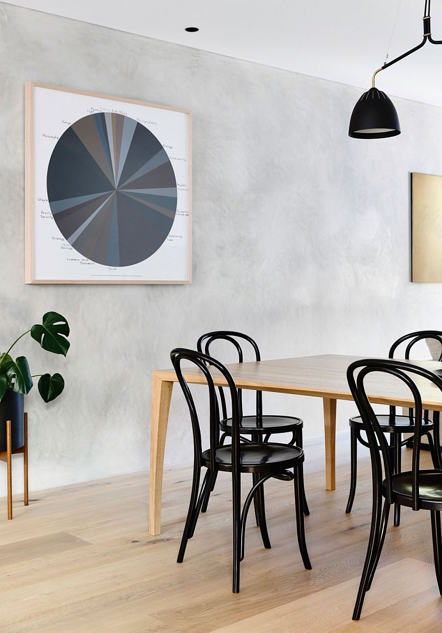 Black dining table chairs anchor the light-filled and cheerful dining room