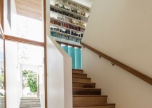 Bookshelf-in-the-stairwell-adds-color-to-the-contemporary-interior-217x155