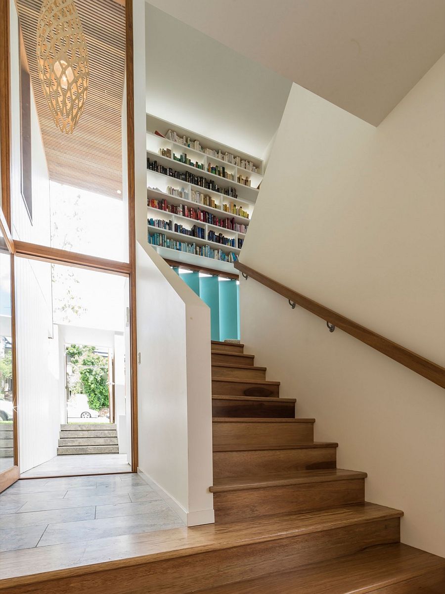Bookshelf in the stairwell adds color to the contemporary interior