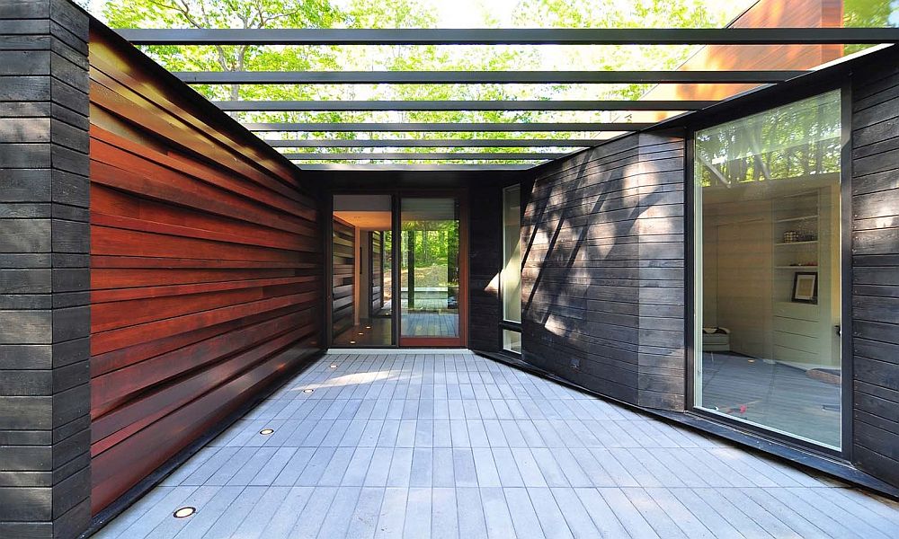 Carefully designed and shiny wall of milled lumber welcomes you at the Pleated House