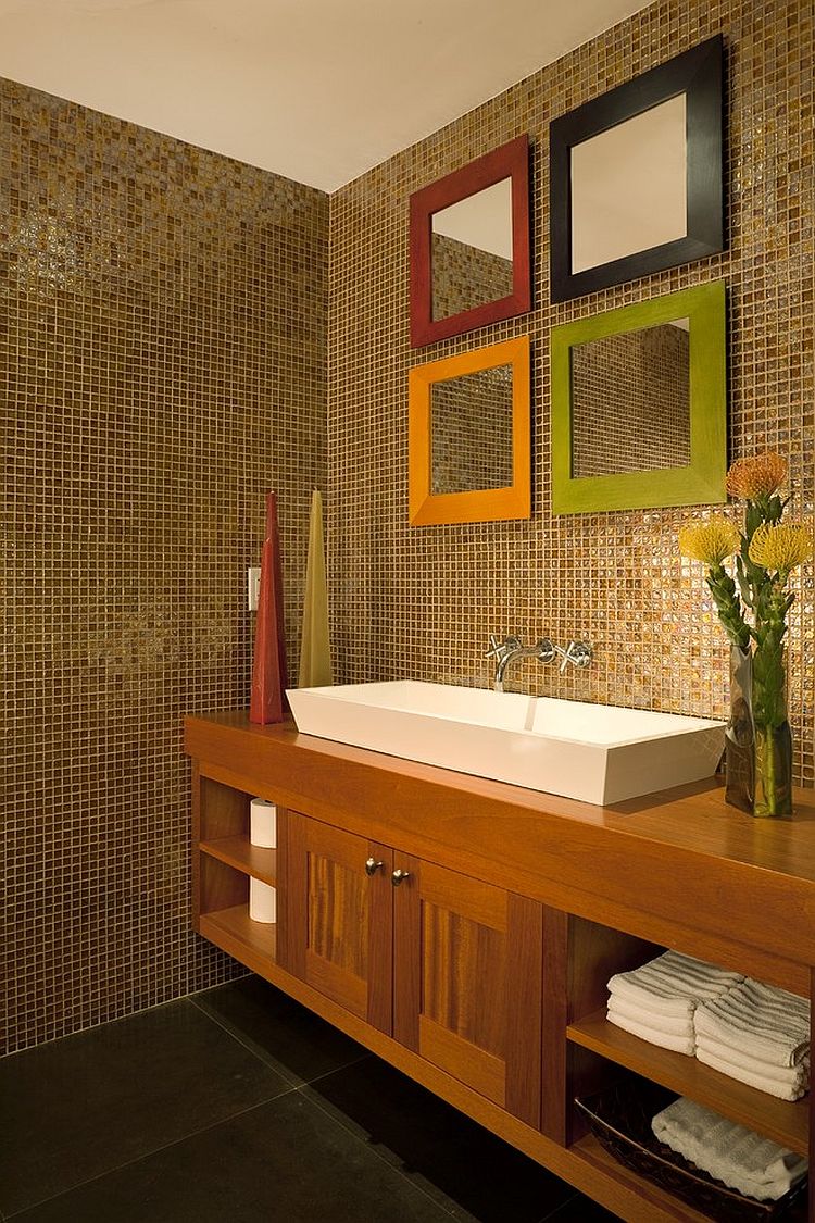 Colorful frames add fun to the mirror collection in the modern powder room [Design: Architectural Design Consultants]