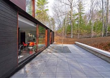 Concrete-patio-around-the-beautiful-forest-house-with-sliding-glass-doors-217x155