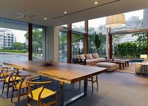 Contemporary-dining-room-of-Sentosa-Cove-home-with-a-view-of-the-canal-and-live-edge-dining-table-217x155