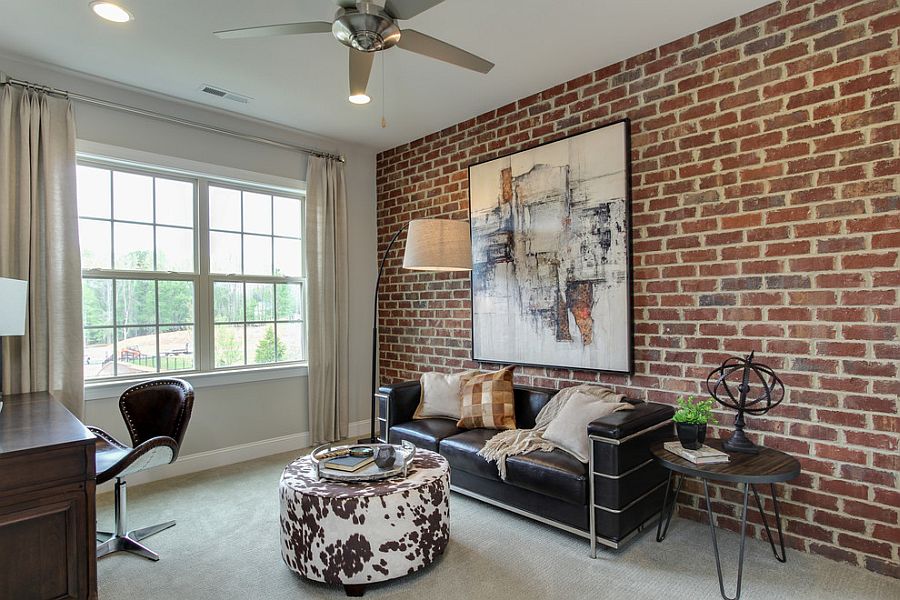 Contemporary home office with brick wall and striking wall art