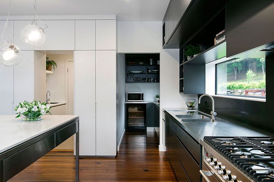 Contemporary kitchen in black and white with a lovely window above the counter