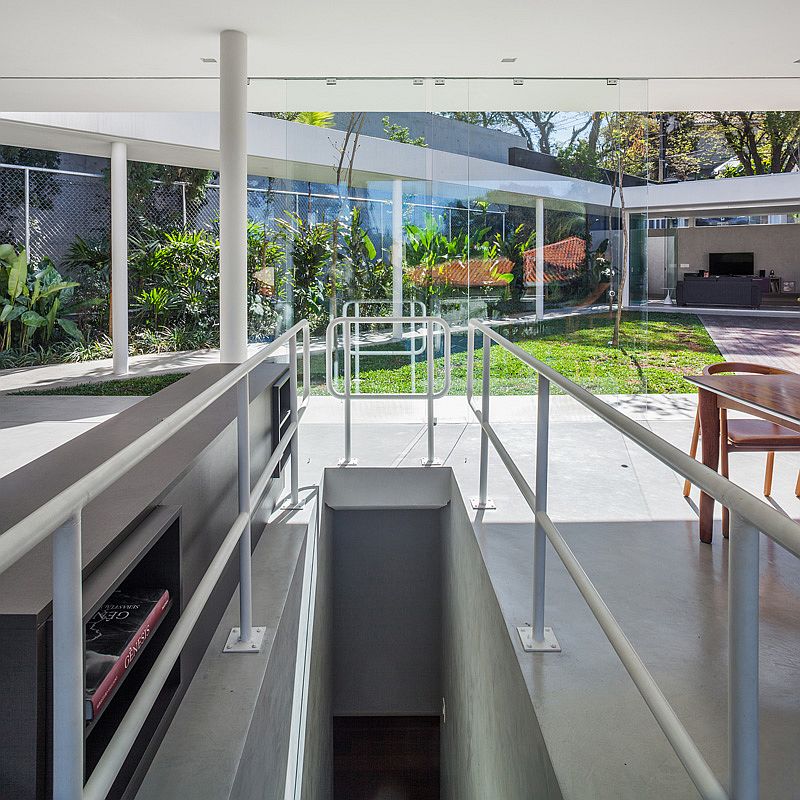 Courtyard of the elegant home with a glass-walled living area