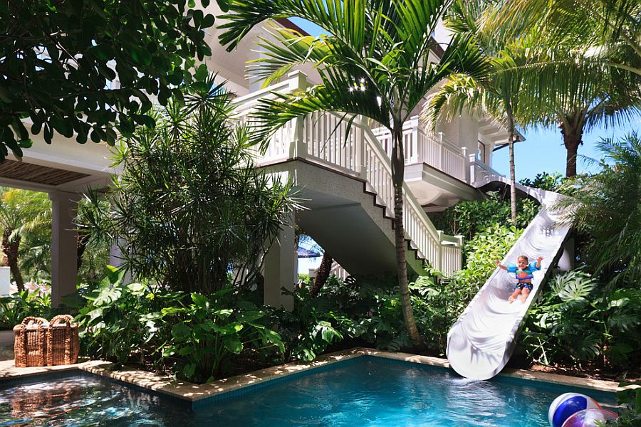 Custom beachfront residence features a slide that leads to the pool!