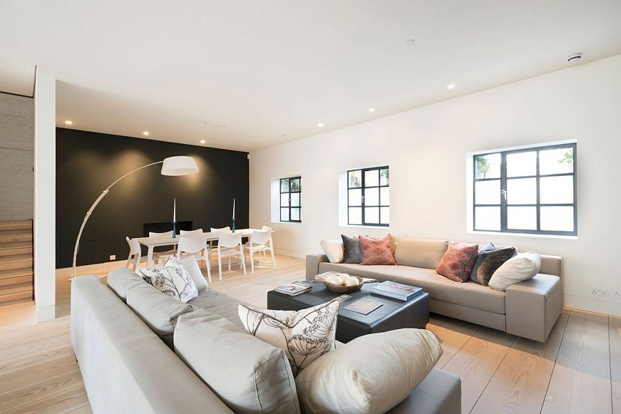 Dark, black accent wall anchors the light-filled, spacious living room