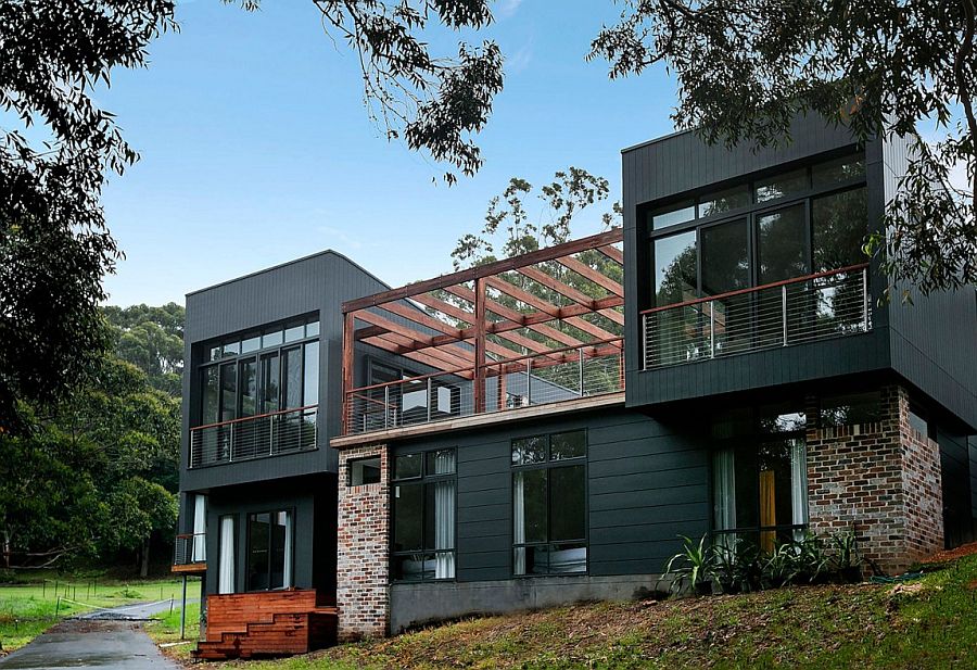 Dark facade and brick walls give the home's facade a unique look