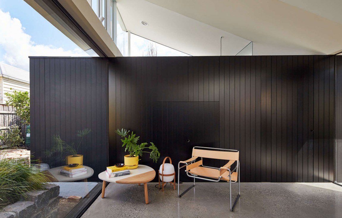 Dark wall adds visual contrast to the open and airy contemporary interior