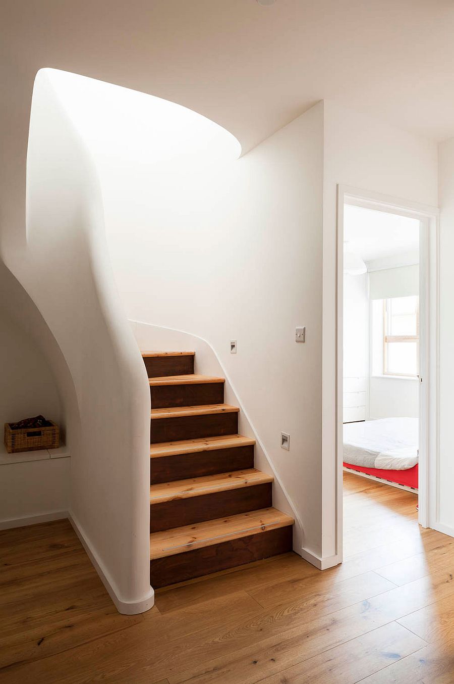 Design of the staircase and rootop terrace brings a flood of light into the lower level as well