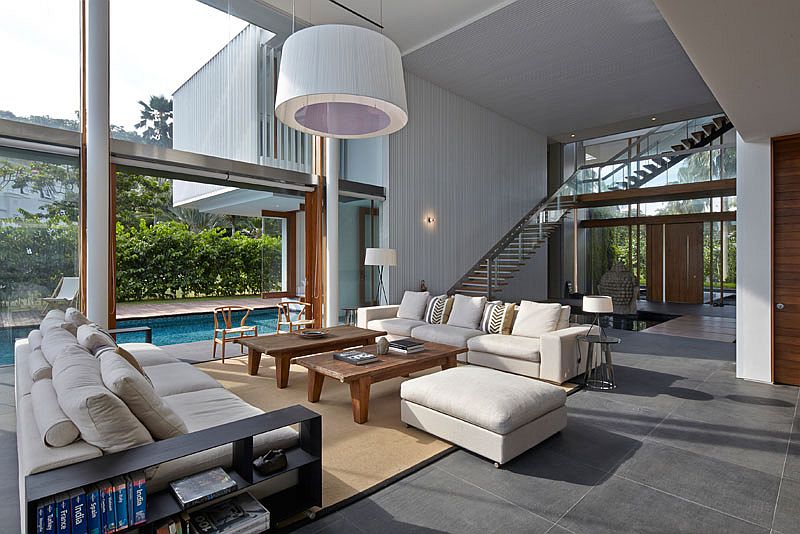 Double-height contemporary living room connected with the pool deck
