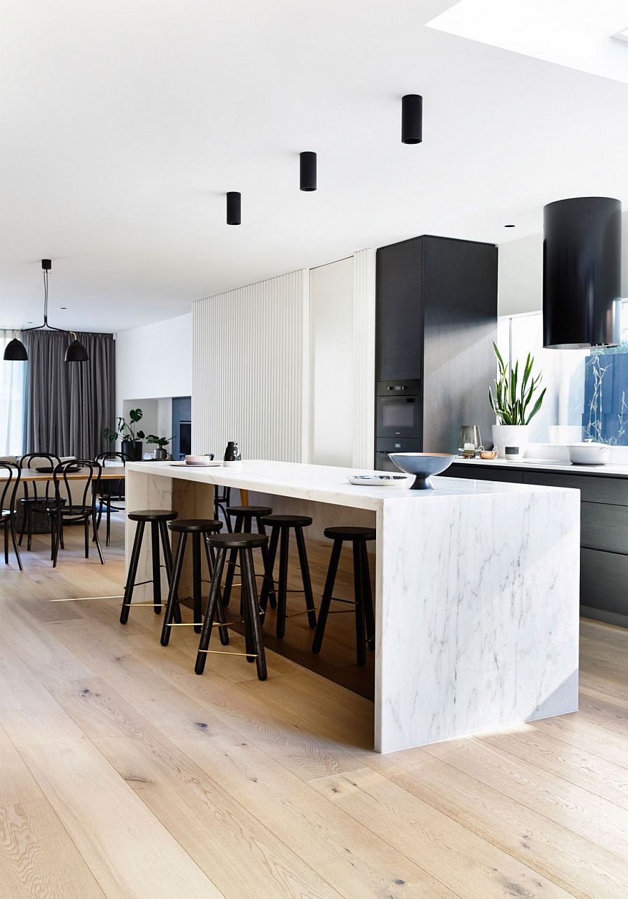 Fabulous marble kitchen island with dark bar stools steals the show