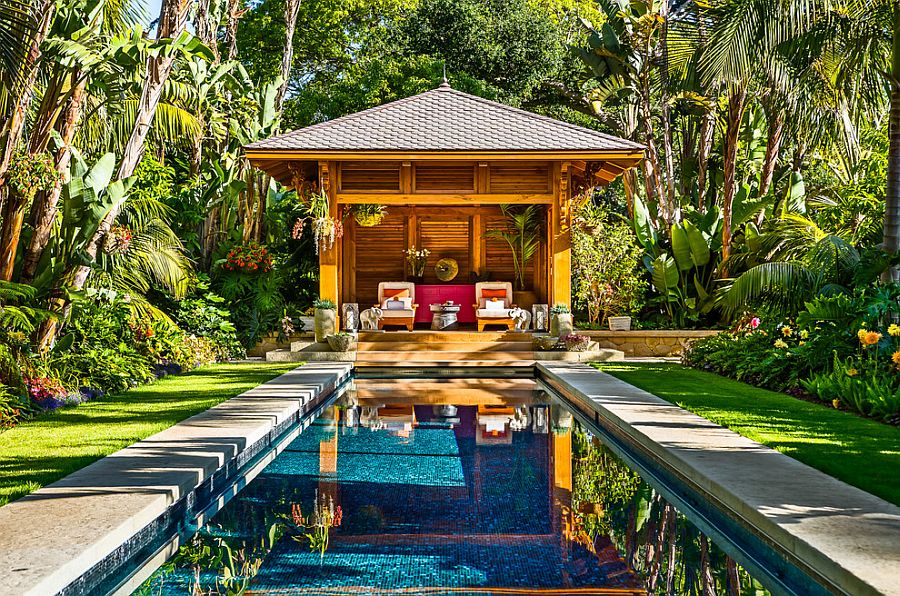 Fabulous tropical pool house and pool surrounded by lush tropical vegetation