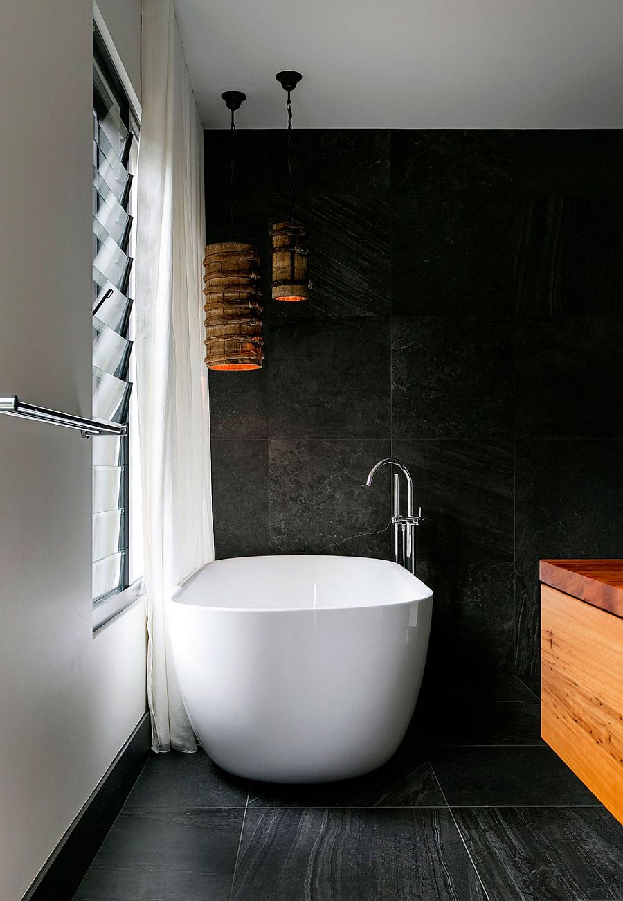 Freestanding bathtub in white set against a dark backdrop