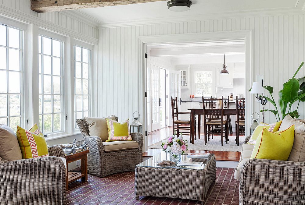 Goregous white, beach style sunroom with simple rattan furniture