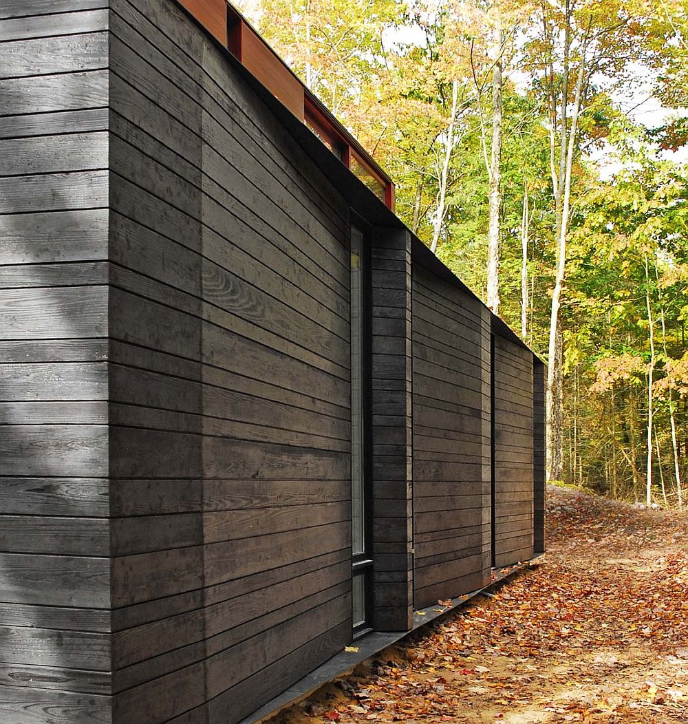 Gorgeous charred cedar siding allows the home to disspear into the forest at night