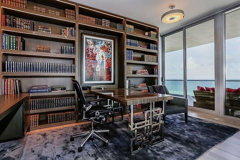 Home office with open bookshelves and ocean views