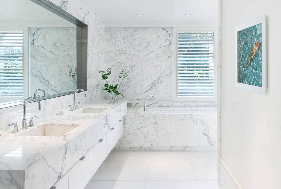 Indulgent contemporary bathroom in white with marble vanity and walls