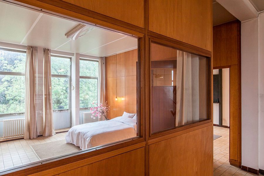 Large glass windows connect the bedroom with the open living space
