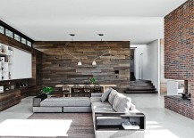 Large-living-area-and-dining-space-with-reclaimed-wood-walls-and-concrete-floor-217x155