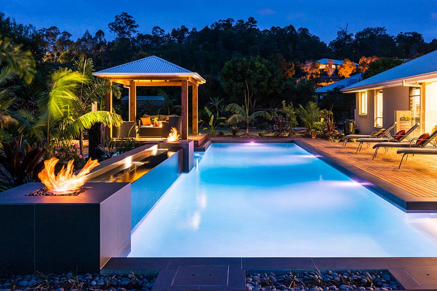 Mesmerizing pool and deck with fire pits and a relaxing outdoor lounge [Design: JB Pool Construction]