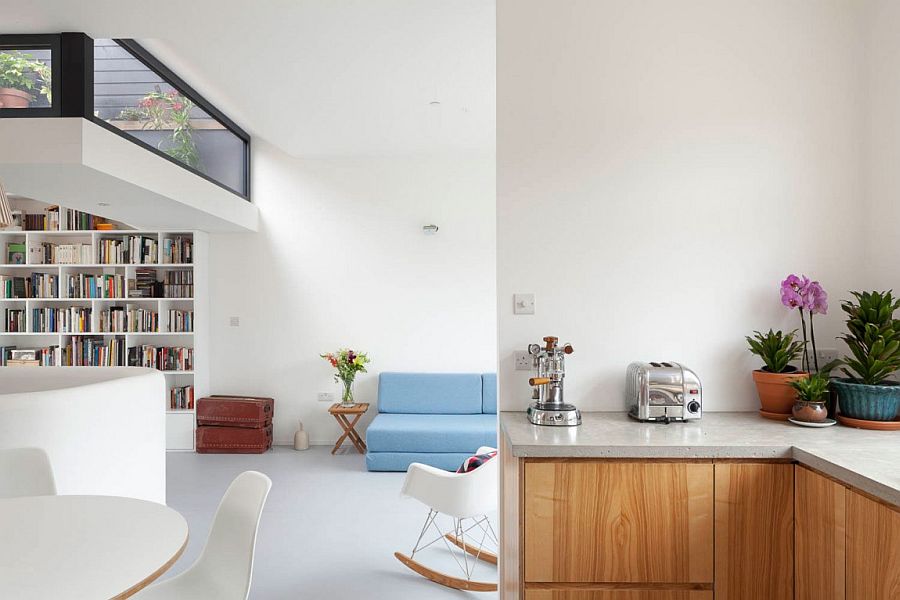 Midcentury classics coupled with large bookshelf and colorful couch in the living room